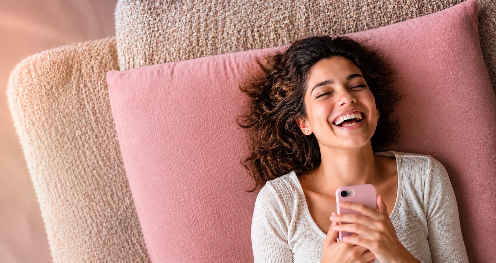 Woman laughing while messaging on her phone